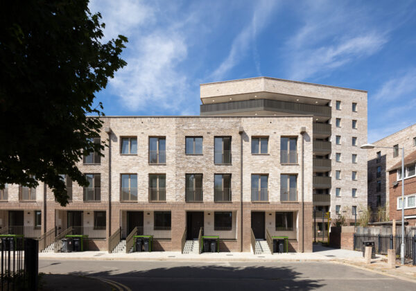 Gascoigne West Phase 1, completion image of a row of houses with a block of flats behind it. 