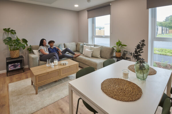 Wates modular homes with woman and child sat in living room.