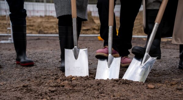 Isle of Wight College groundbreaking with a shovel and boots