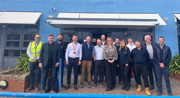 Mark Craig and the Construction team posing outside the building