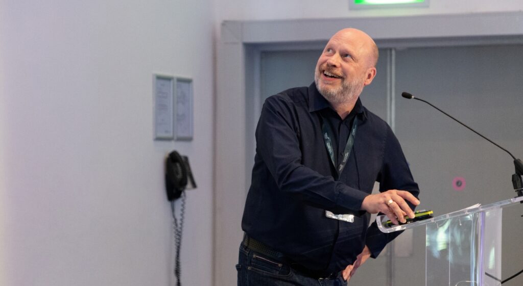 Neil Page presenting and smiling