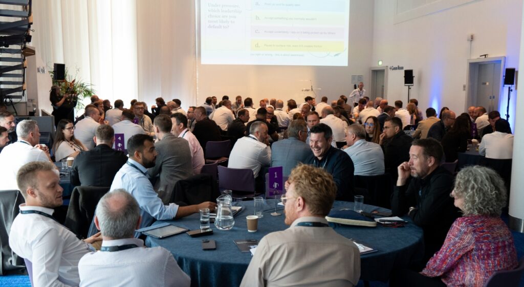 good shot from back of the room looking towards presenter on stage